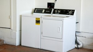 A front-loading white washer and dryer unit with a control panel, a yellow energy efficiency sticker, and a power cord plugged in. - Spacious 3BR Home in Clinton. Weekly & Monthly Discounts Available! (Clinton)