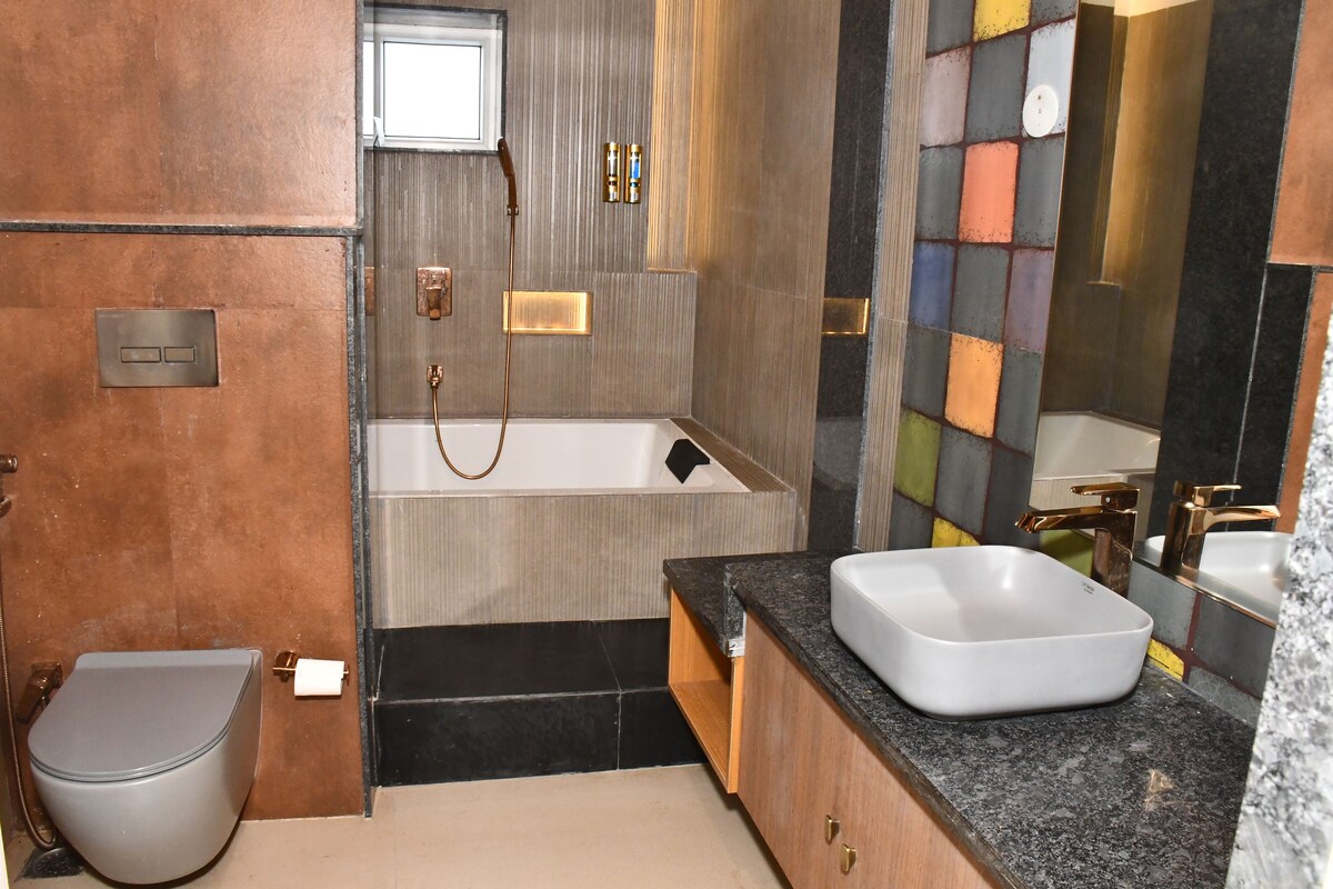 A bathroom with a bathtub, a toilet, and a sink.