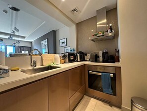 Fridge, microwave, oven, stovetop - 1BR with Burj Khalifa View in Paramount Hotel (Dubai)