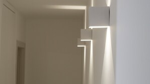 A hallway with modern wall-mounted lighting fixtures.