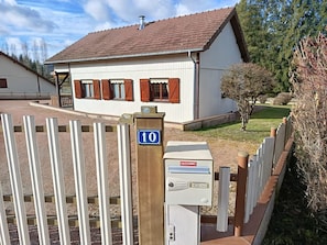 A residential building with a number 10 sign, a gated entrance, and a mailbox.