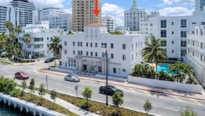 A coastal cityscape with modern buildings, a prominent white building with a central entrance, and a clear blue sky. - Miami Beach Escape Delightful 1 Bedroom  (Miami Beach)