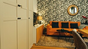 A compact living space with a sofa, a small table, and a lamp. - Duplex with wonderful views, next to the historic center and walking trails. (Cazorla)