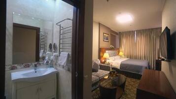 Deluxe Double Room, Non Smoking | Bathroom | Shower, slippers, towels, soap