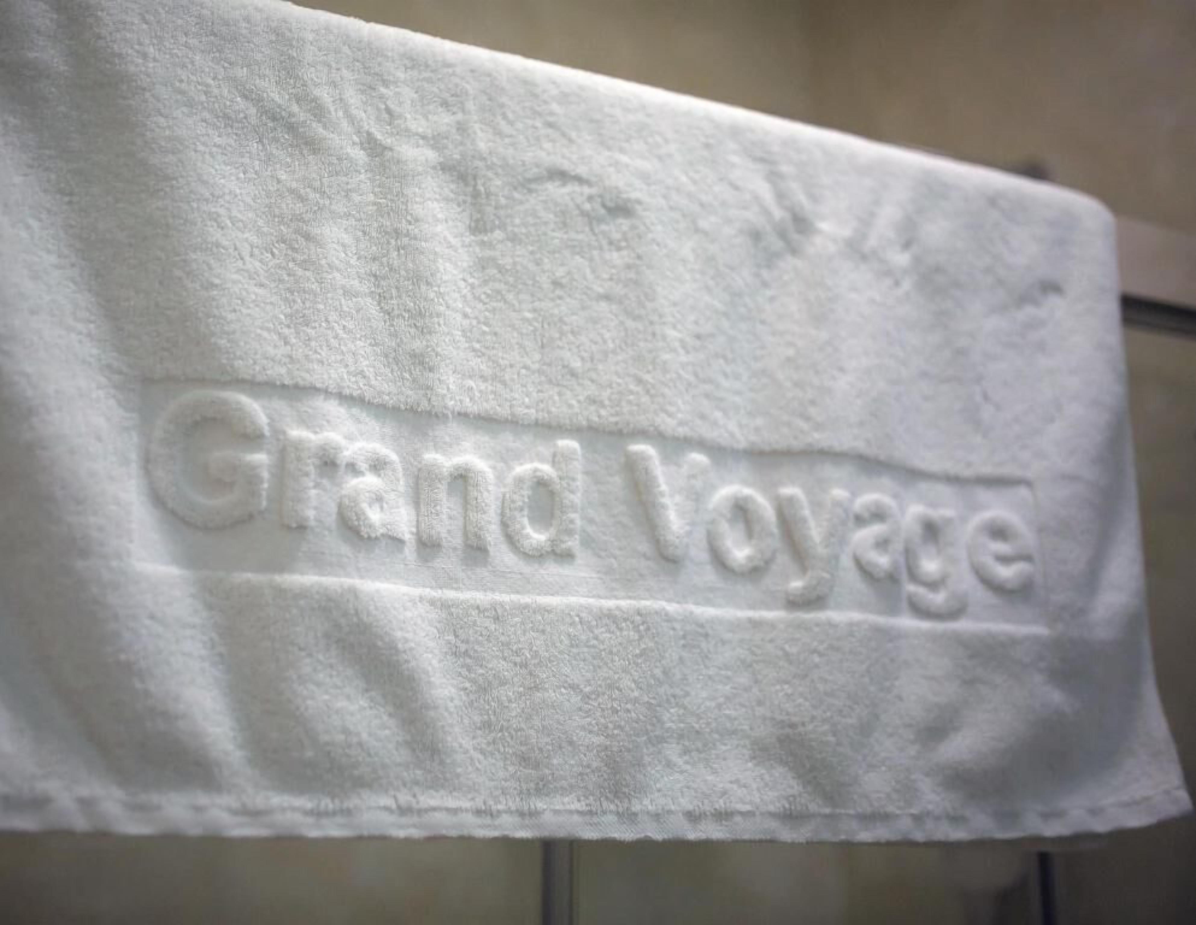 A towel with "Grand Voyage" embossed on it.