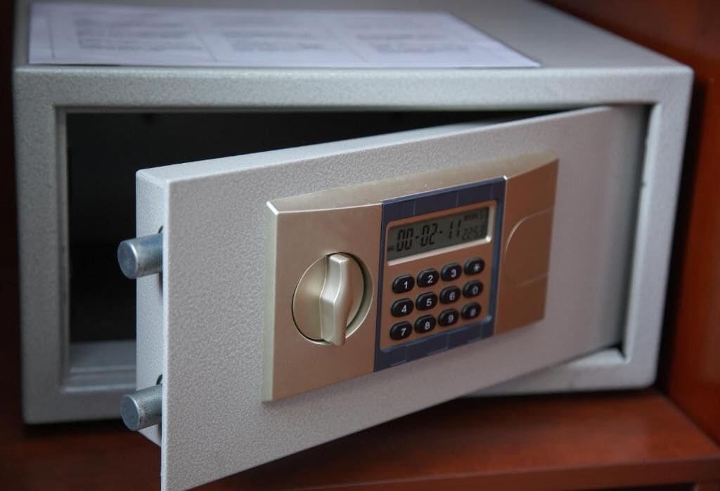 A safe with a digital keypad and a combination lock.