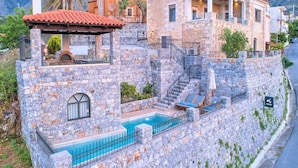 A stone villa with a pool, a terrace, and a mountain backdrop. - "Acrothea Villa Beheizter Pool" by Interhome (Georgioupoli)