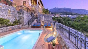 A stone building with a swimming pool, outdoor seating, and a view of the mountains. - "Acrothea Villa Beheizter Pool" by Interhome (Georgioupoli)
