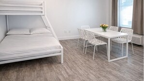 A room with a bunk bed, a dining table with chairs, and a window with curtains. - Miami Beach Escape Delightful 1 bdr Stay (Miami Beach)