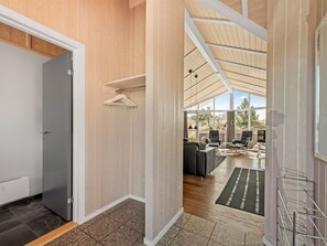 A modern interior with a wooden ceiling, a grey door, and a seating area with a view. - "Arine" - 700m to the fjord by Interhome (Hvide Sande)