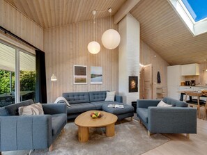 A modern living room with a sectional sofa, a coffee table, and a fireplace. - "Yorick" - 350m to the fjord by Interhome (Tarm)