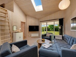 A modern living room with a large sectional sofa, a television, and a skylight. - "Yorick" - 350m to the fjord by Interhome (Tarm)