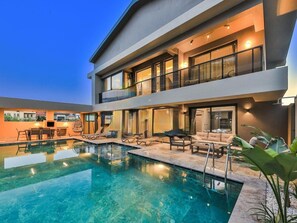 A modern two-story house with a swimming pool, outdoor seating, and a balcony. - Zentrale in Fethiye by Interhome (Ölüdeniz)
