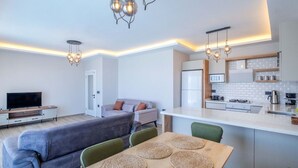 A modern apartment with a living room, dining area, and kitchen. - Villa mit Infinitypool in Fethiye Faralya by Interhome (Ölüdeniz)