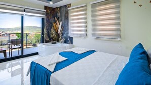A bedroom with a bed, a large window, a ceiling mural, and a view of the outside.