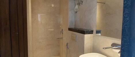 A modern bathroom with a shower, toilet, and sink.
