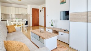 A modern apartment with a living room, kitchen, and dining area. - Wohnung "Lux" mit Meerblick by Interhome (Herceg Novi)