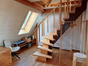 A loft-style room with a wooden staircase, a desk, and a chair. - Freiburg-Herdern, a suburban, near-natural area! (Freiburg im Breisgau)