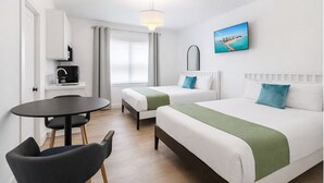 A hotel room with two beds, a small table, a chair, a desk with a radio, and a window with curtains. - Relaxing Miami Beach Getaway Near  Ocean (Miami Beach)
