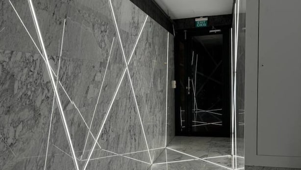 A modern hallway with marble walls and floors, featuring geometric light patterns. - the business class suit karkoy (Istanbul)