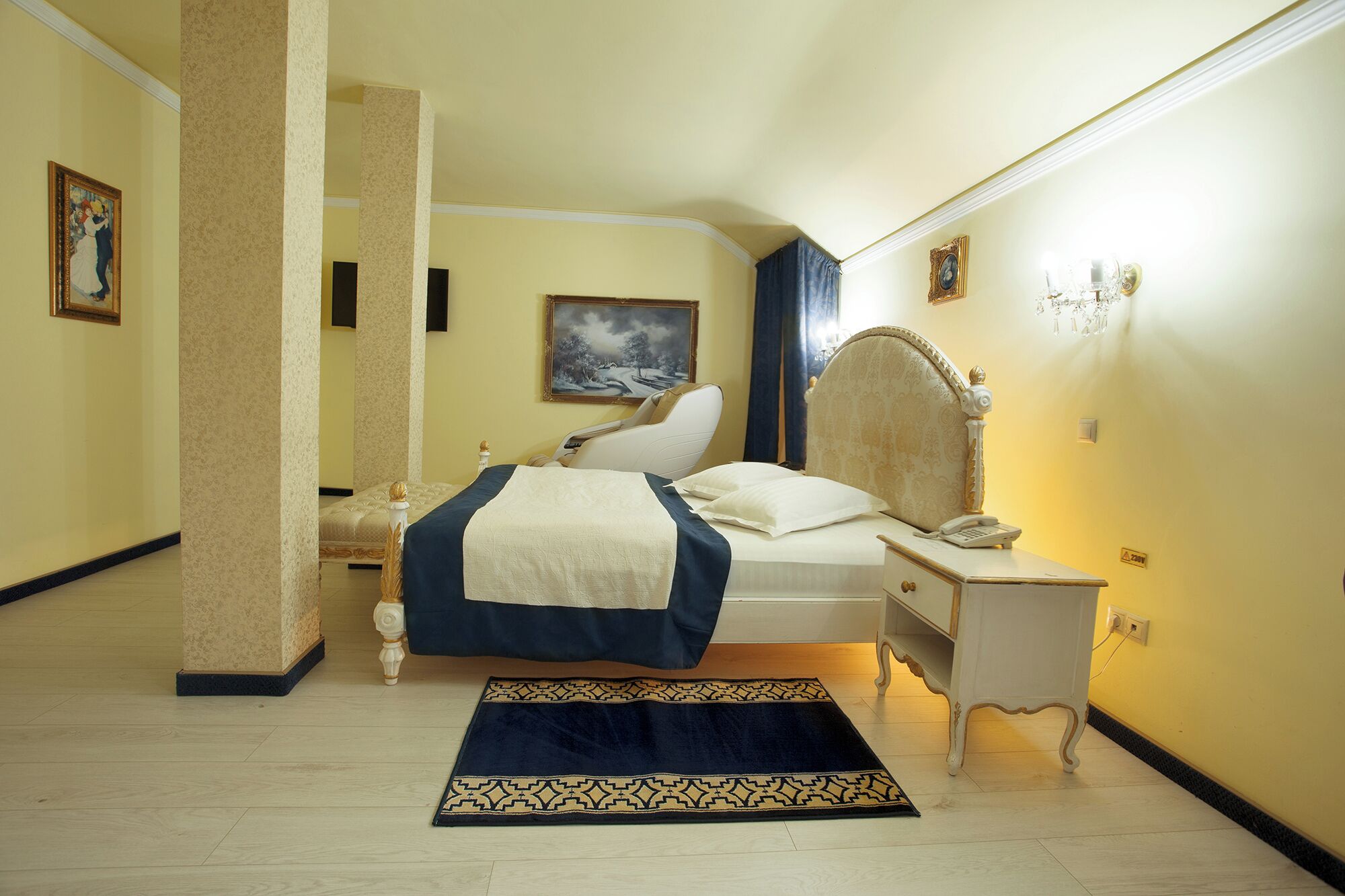 A hotel room with a bed, bedside table, and a nightstand.