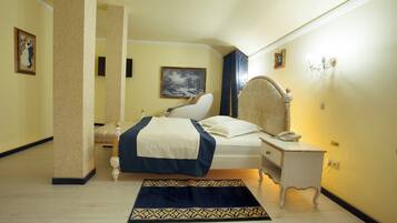 A hotel room with a bed, bedside table, and a nightstand.