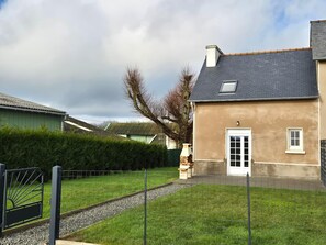A residential property with a well-maintained lawn, a gravel pathway, and a metal gate. - Terraced Country House Near Sea (Plurien)