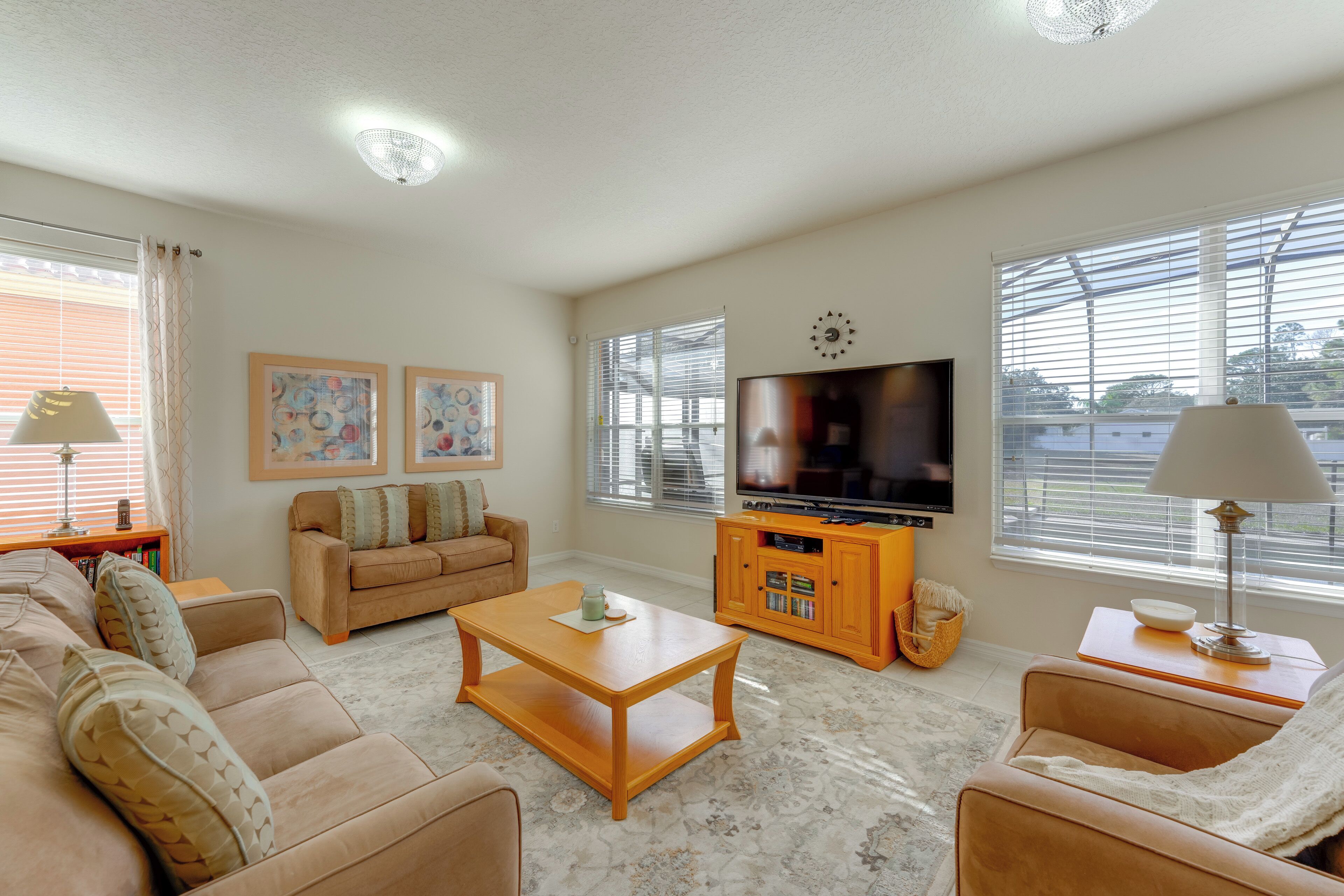 A living room with a sofa, a coffee table, a TV, and a lamp.