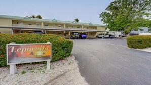 A Lemporello Condominium with a green roof, a covered parking area, and a signboard. - Walk to Beach! Treasure Island Gem w/ Water Views (Treasure Island)