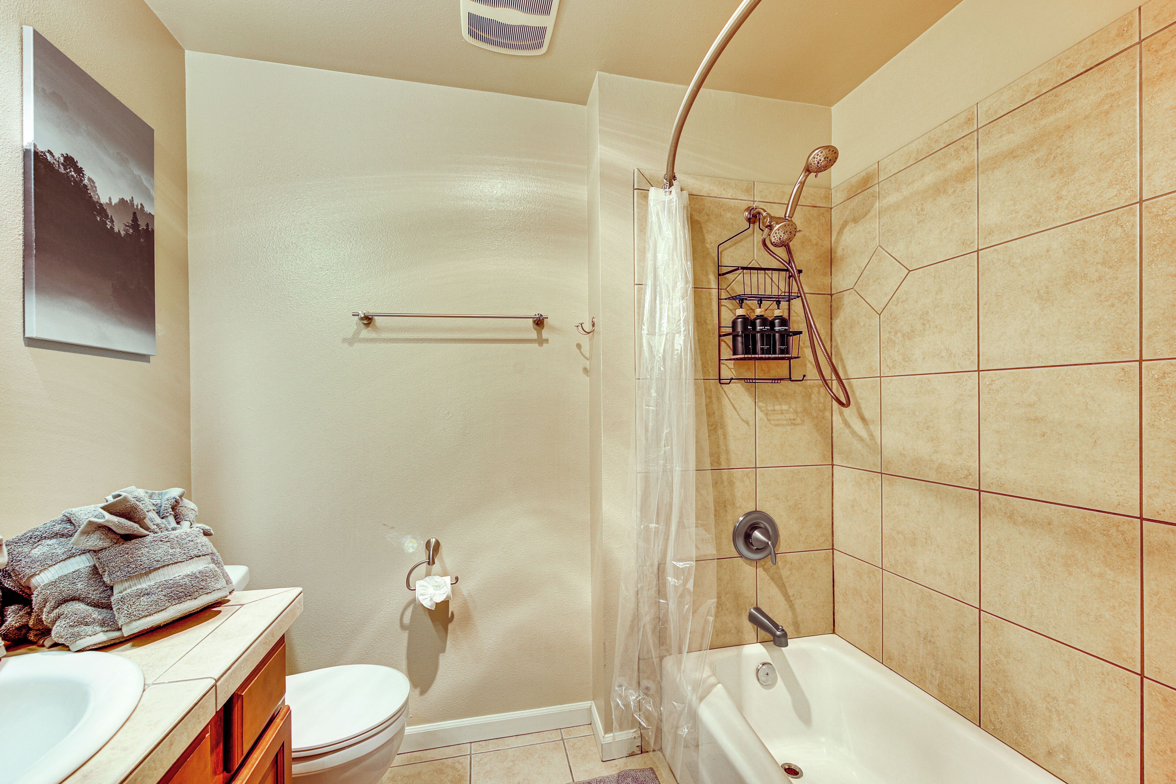 Un baño con bañera, inodoro y lavamanos.