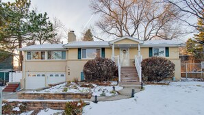 A two-story house with a front porch, a garage, and a snow-covered yard. - 2 Mi to Old Town: Pet-friendly Home Base in Arvada (Arvada)