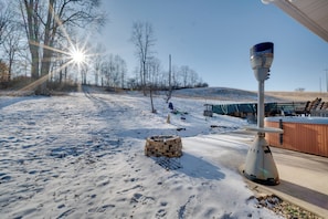 A snow-covered outdoor area with a hot tub, a wooden structure, and a telescope. - 5-acre Hocking Hills Hideaway! Pet-friendly Home (New Plymouth)