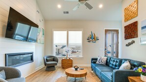 A modern living room with a flat-screen TV, leather sofa, and a round coffee table. - Lake Greenwood Access: Modern Escape w/ Patio! (Greenwood)