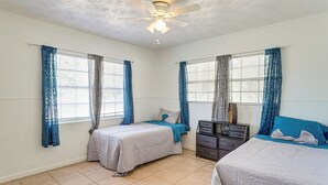 A bedroom with two beds, a ceiling fan, and a dresser. - Hike & Fish! Wooded Family Getaway in Interlachen (Interlachen)