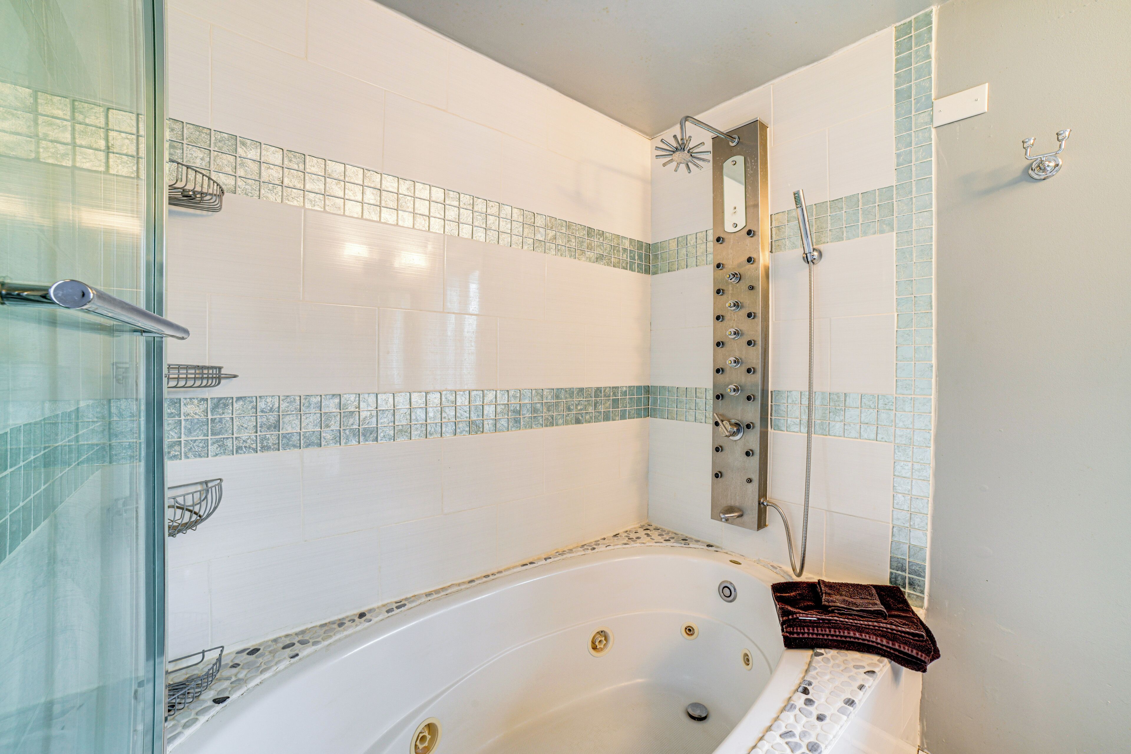 A bathroom with a bathtub, shower, and glass shower enclosure.