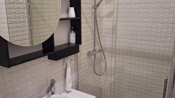 Studio Suite | Bathroom | Shower, towels, soap, toilet paper