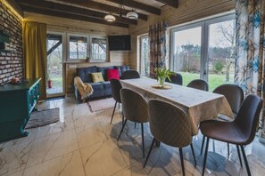 A dining area with a table, chairs, and a view of the outdoors. - Large Holiday Home, Salt Cave, Sauna, Jacuzzi (Lipusz)