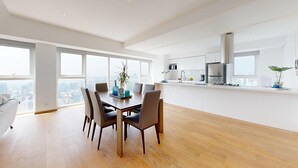 A modern kitchen with white cabinets, stainless steel appliances, and a large window overlooking a cityscape. - Start 2026 in a penthouse with amenities (Ciudad de México)