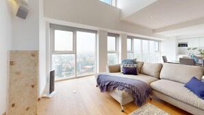 A spacious living room with a large window, a sofa, a coffee table, and a flat-screen TV. - Start 2026 in a penthouse with amenities (Ciudad de México)