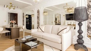 A modern living room with a sofa, coffee table, and decorative lamps. - A BLEND OF CLASSIC PARISIAN CHARM WITH MODERN SOPHISTICATION NEXT TO THE LOUVRE (Paris)