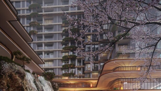 A modern hotel with a waterfall, koi pond, and cherry blossoms.