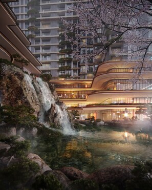 A modern hotel with a waterfall, koi pond, and cherry blossoms. - Ecopark Swanlake Mori Onsen by ATV (Phung Cong)