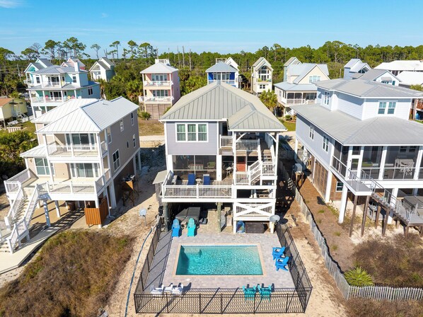 A beachfront property with multiple houses, a swimming pool, and a fenced deck area. - 🌴 Gulf Front Home - Private Pool - Sweet Retreat 🌴 (Indian Pass)