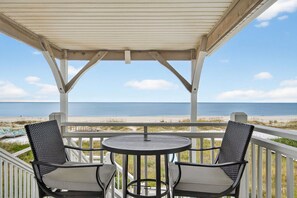 A covered outdoor seating area with a view of the beach and ocean. - 🌴 Gulf Front Home - Private Pool - Sweet Retreat 🌴 (Indian Pass)