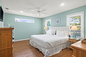 A bedroom with a large bed, two bedside tables, a ceiling fan, and a window with blinds. - Experience "Absolute Bliss" - Private Pool, Gulf Front (Indian Pass)
