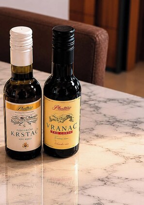 Two bottles of wine on a marble surface. - Ulcinj Vibes & Waves Apartment (Ulcinj)