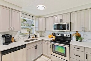 Microwave, oven, stovetop, dishwasher - Right at Home Stays - Modern 2BR 2BA w/ Yard & Fireplace (Pinellas Park)