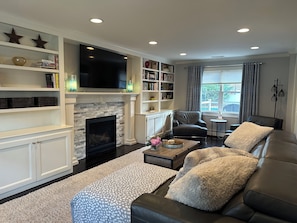 Smart TV, fireplace, books, printers