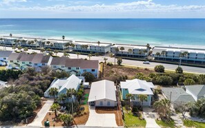 A coastal residential area with beachfront properties, including houses and a hotel with a beach view.