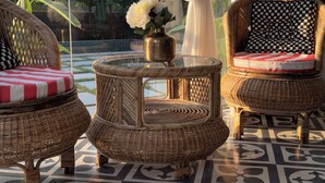 A room with wicker furniture, a glass table, and a patterned floor. - A 3BHK Luxury Villa with Pvt Pool, Garden Near Beach (Siolim Goa)